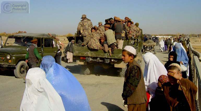 Women in Burkas in Front of Convoy